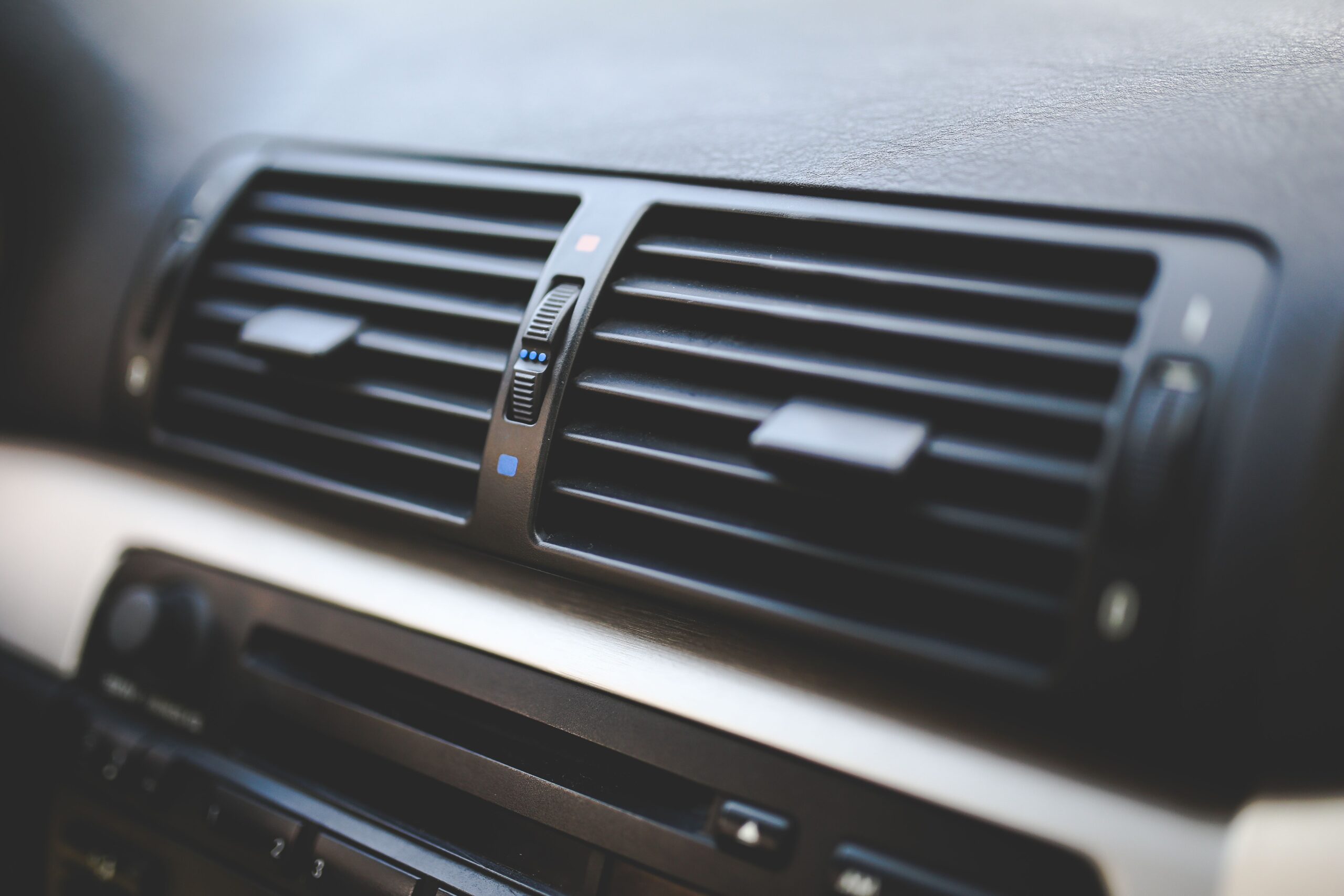Home Detailed view of air conditioning vents in the interior of a BMW car, showcasing modern automotive design.