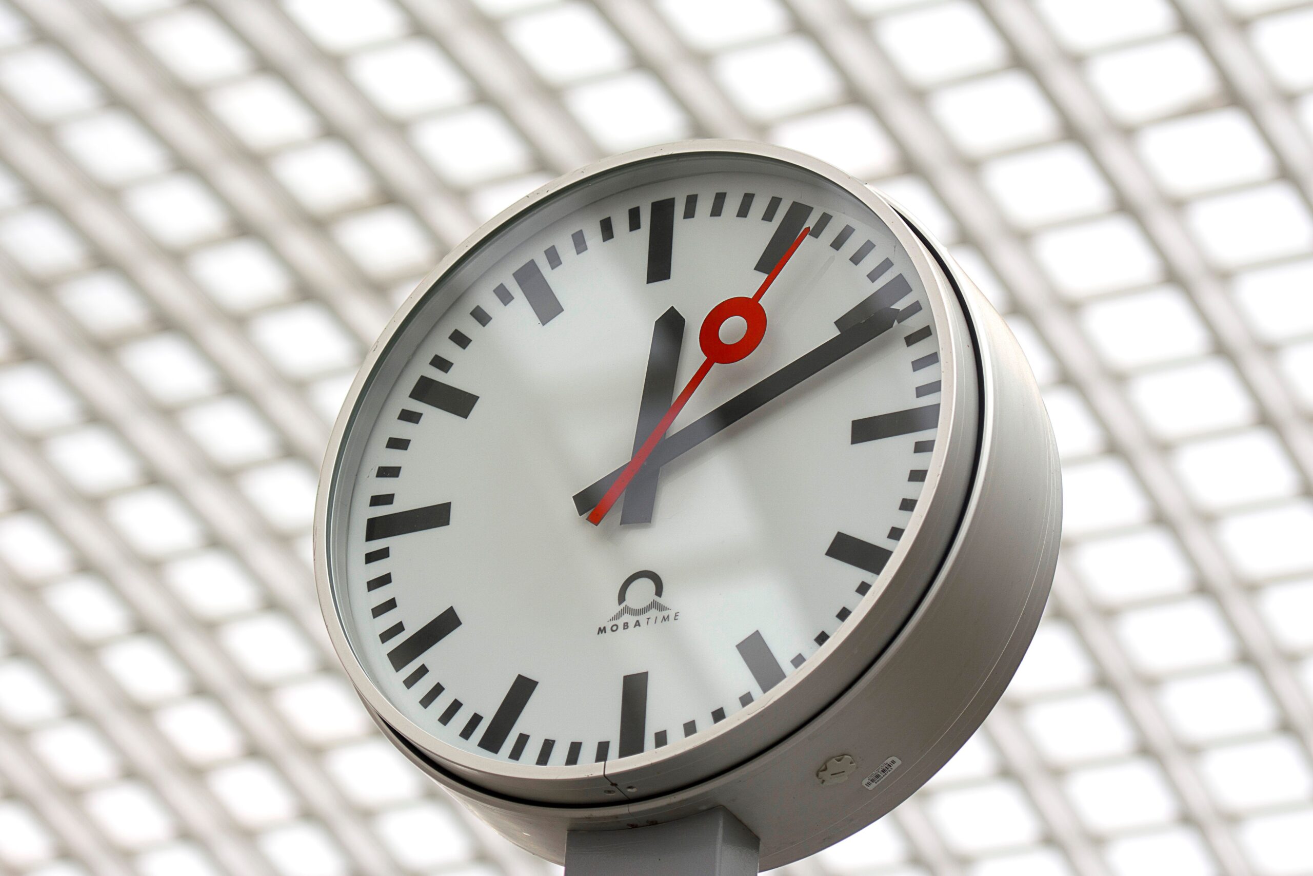 Home Close-up of a modern analog clock against a geometric background, perfect for time-related themes.
